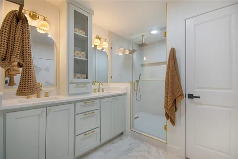 a bathroom with a double vanity sink and a mirror