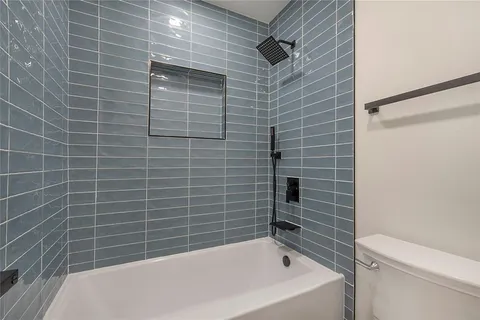 a bathroom with a bathtub and a shower