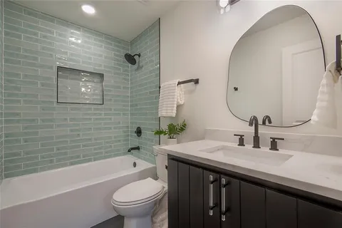 a bathroom with a sink a toilet and a mirror