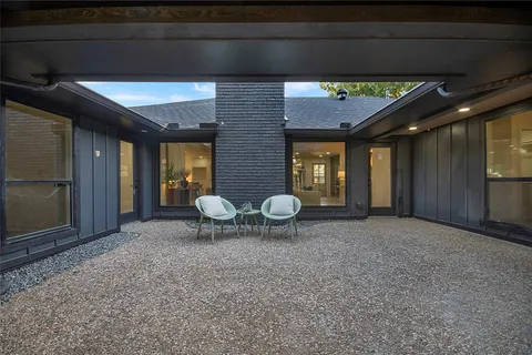 a view of a porch with a table and chairs