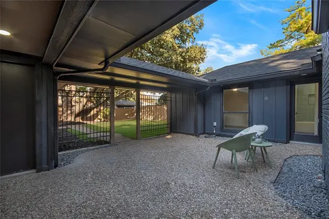a view of a porch with furniture and floor to ceiling window
