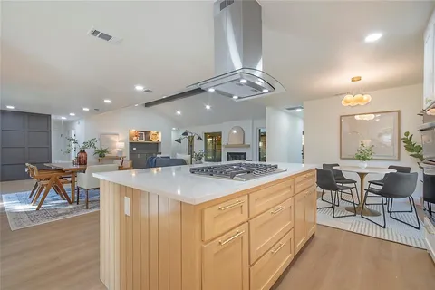 a large kitchen with a table and chairs