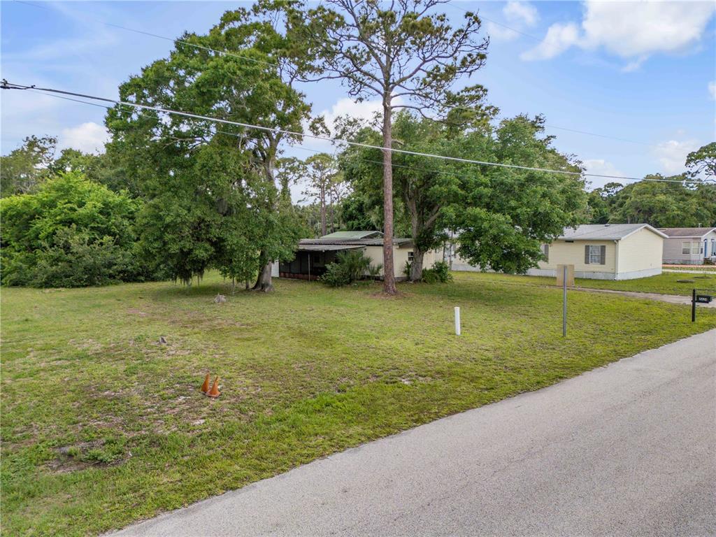 Nellie Street Edgewater, FL 32141 - Photo 2 of 27 a view of a garden with a bench