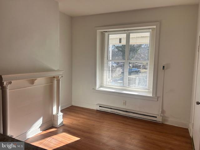513 Brinton Street, Unit 1 Philadelphia, PA 19144 - Photo 2 of 13 an empty room with wooden floor and windows