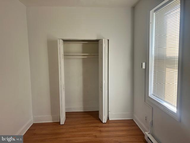 513 Brinton Street, Unit 1 Philadelphia, PA 19144 - Photo 7 of 13 a view of an empty room with wooden floor and a window