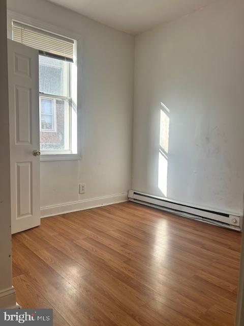 513 Brinton Street, Unit 1 Philadelphia, PA 19144 - Photo 9 of 13 an empty room with wooden floor and windows