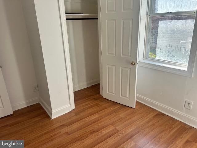 513 Brinton Street, Unit 1 Philadelphia, PA 19144 - Photo 10 of 13 an empty room with wooden floor and a window