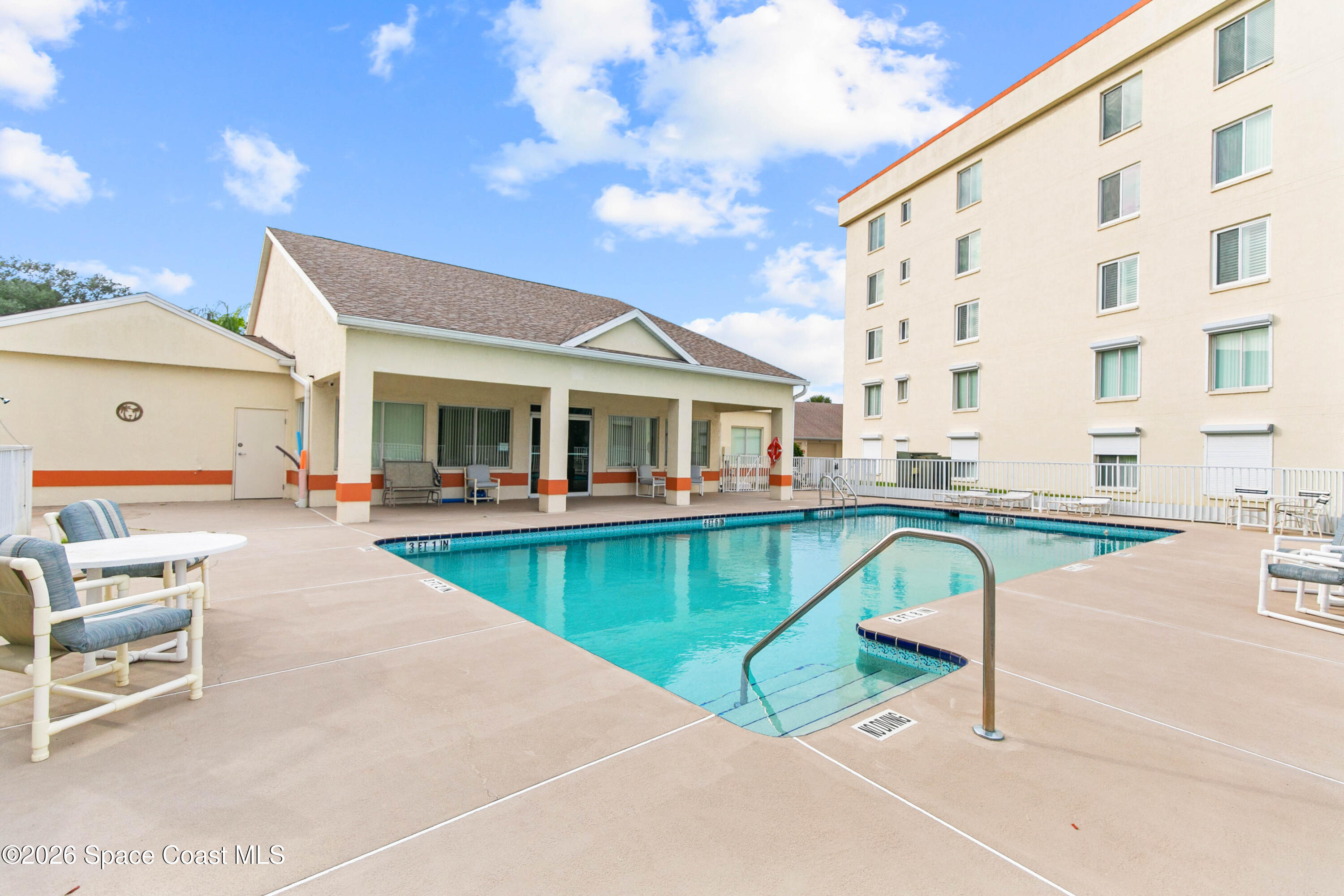 1410 Huntington Lane, Unit 1106 Rockledge, FL 32955 - Photo 21 of 23 a view of house with swimming pool and sitting area