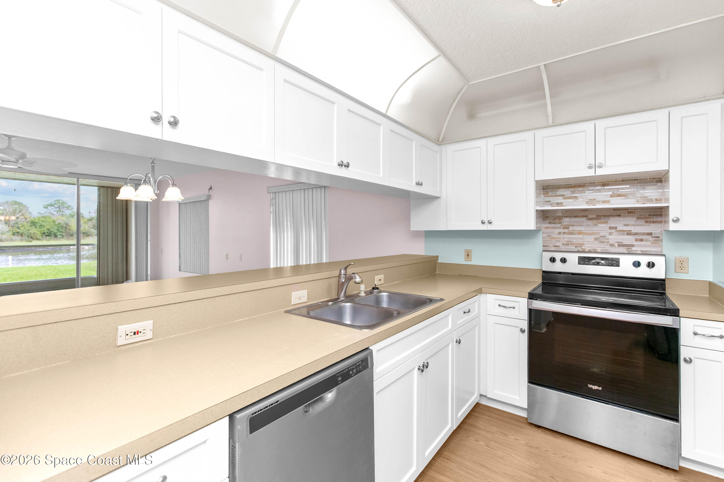 1410 Huntington Lane, Unit 1106 Rockledge, FL 32955 - Photo 3 of 23 a kitchen with a sink stove and cabinets