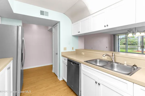 a kitchen with a sink and a refrigerator