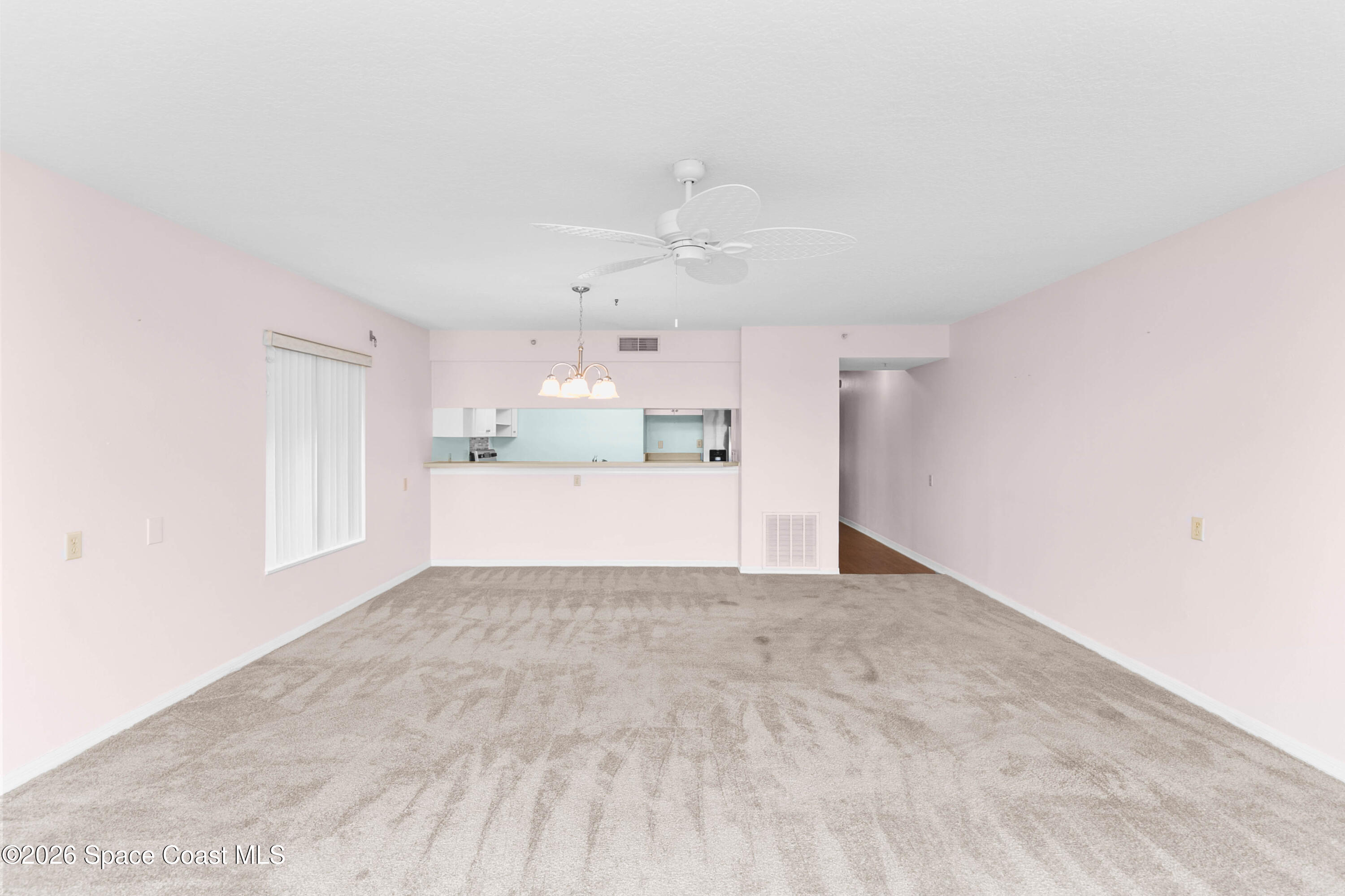1410 Huntington Lane, Unit 1106 Rockledge, FL 32955 - Photo 9 of 23 a view of a kitchen with a sink and a refrigerator