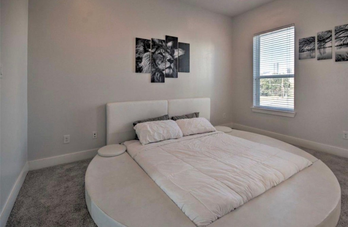 2107 Stuart Street Houston, TX 77004 - Photo 13 of 30 a bedroom with a bed and a window