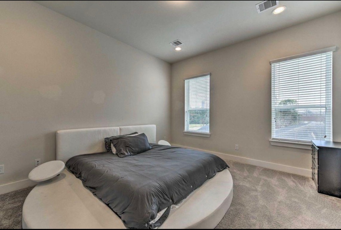 2107 Stuart Street Houston, TX 77004 - Photo 16 of 30 a bedroom with a bed and window