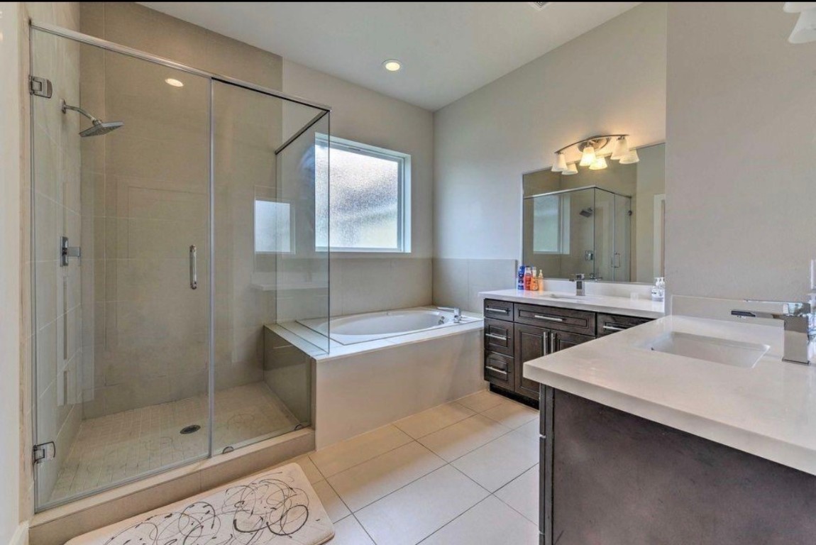 2107 Stuart Street Houston, TX 77004 - Photo 18 of 30 a bathroom with a sink vanity granite tub and shower