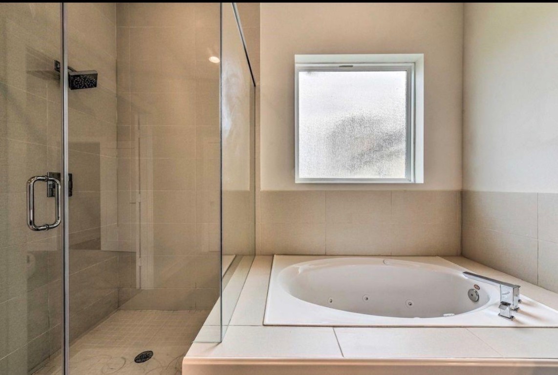 2107 Stuart Street Houston, TX 77004 - Photo 20 of 30 a bathroom with a bathtub and shower