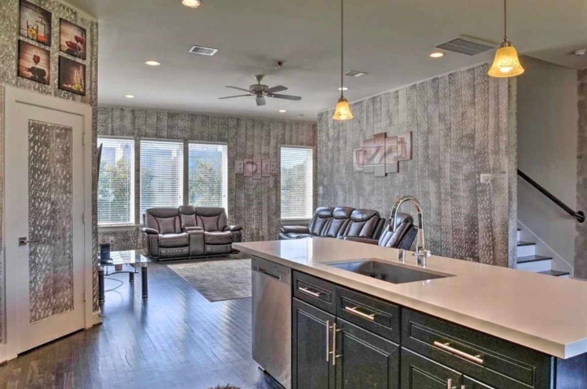 2107 Stuart Street Houston, TX 77004 - Photo 2 of 30 a kitchen with a sink a counter space dining table and chairs