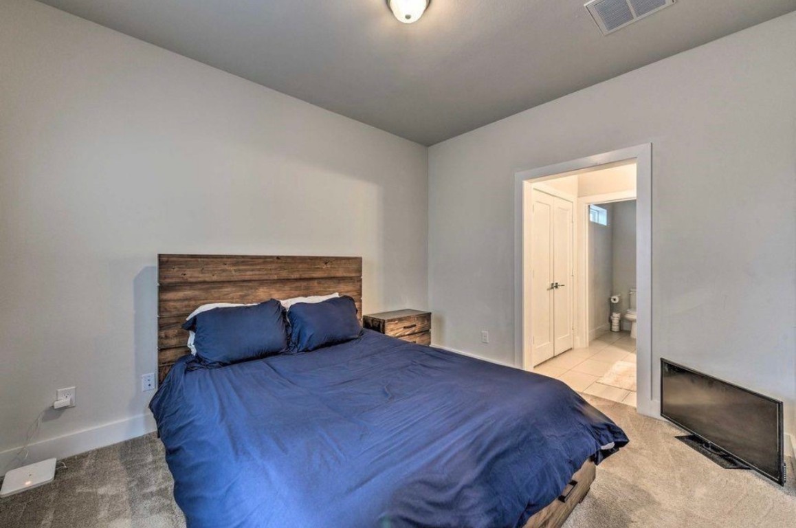 2107 Stuart Street Houston, TX 77004 - Photo 21 of 30 a bedroom with a bed and a window