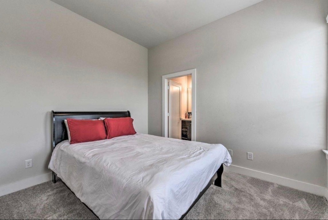 2107 Stuart Street Houston, TX 77004 - Photo 22 of 30 a bedroom with a bed and a window