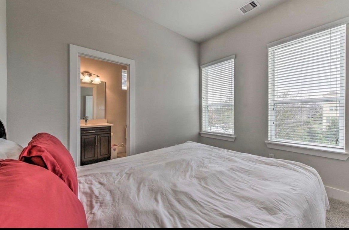 2107 Stuart Street Houston, TX 77004 - Photo 26 of 30 a bedroom with a bed and a window