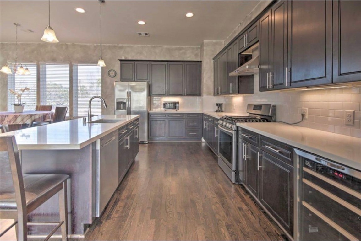 2107 Stuart Street Houston, TX 77004 - Photo 4 of 30 a kitchen with stainless steel appliances a sink stove and cabinets