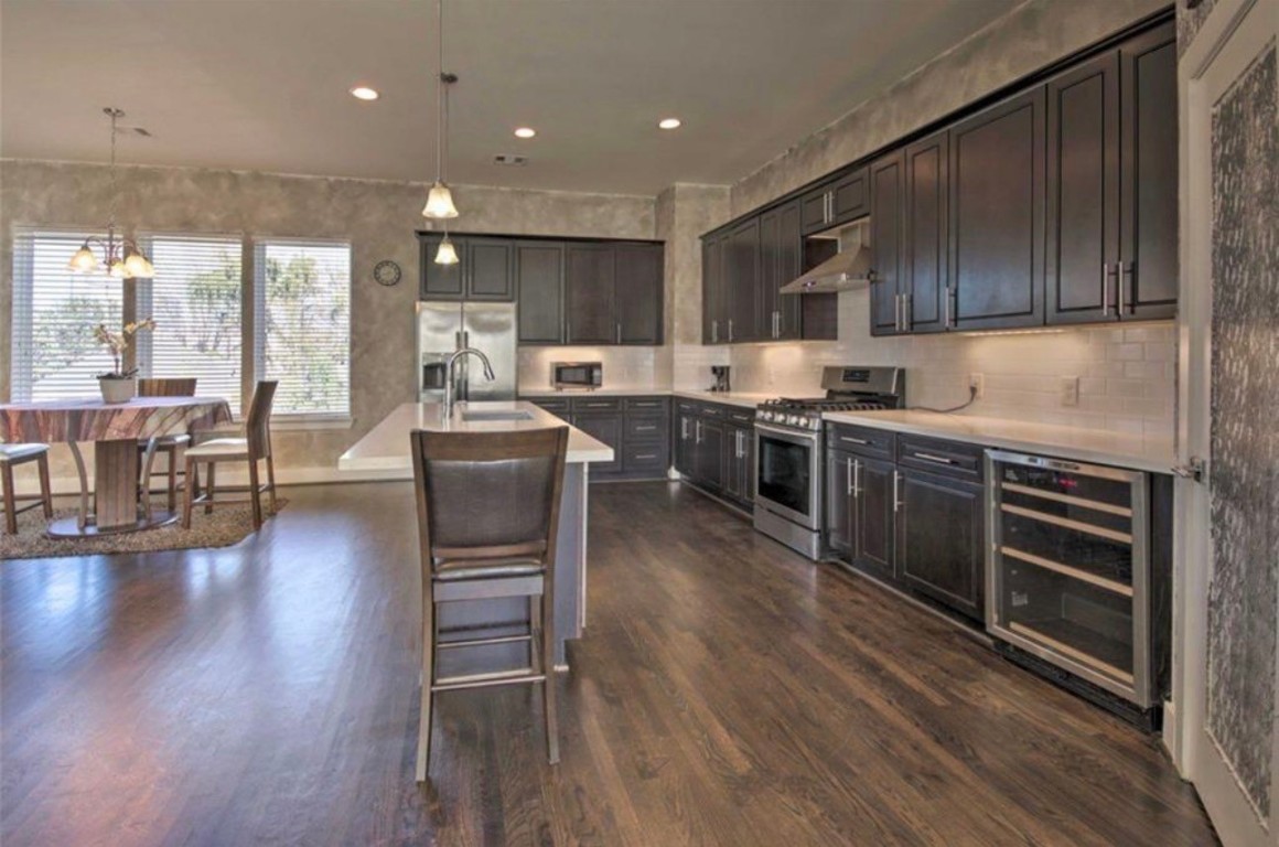 2107 Stuart Street Houston, TX 77004 - Photo 5 of 30 a kitchen with stainless steel appliances granite countertop wooden floors and view living room
