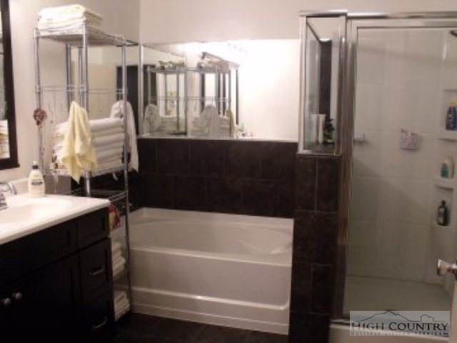 23 Kilby Road Sparta, NC 28675 - Photo 3 of 30 a bathroom with a sink a mirror and a bathtub