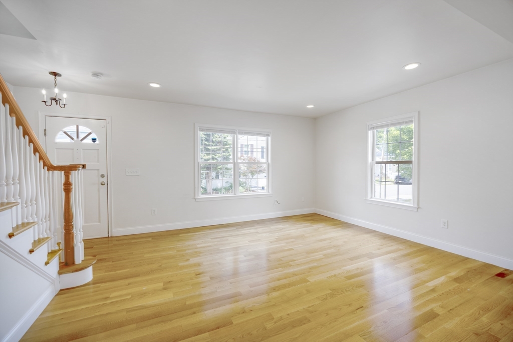 48 Spruce Street, Unit 1 Winchester, MA 01890 - Photo 3 of 29 a view of empty room with wooden floor and fan