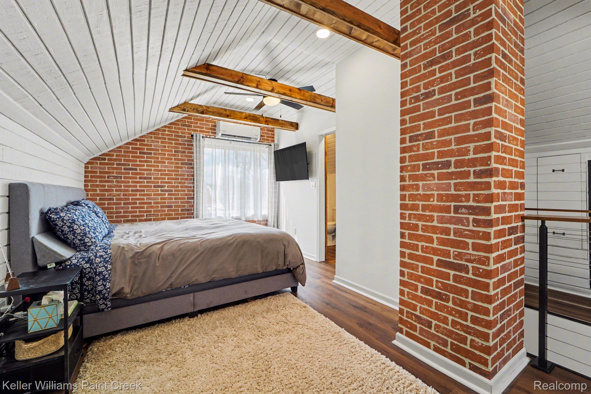1404 West Eleven Mile Road Berkley, MI 48072 - Photo 11 of 20 Featuring angled ceilings, wood beams, and brick accents.