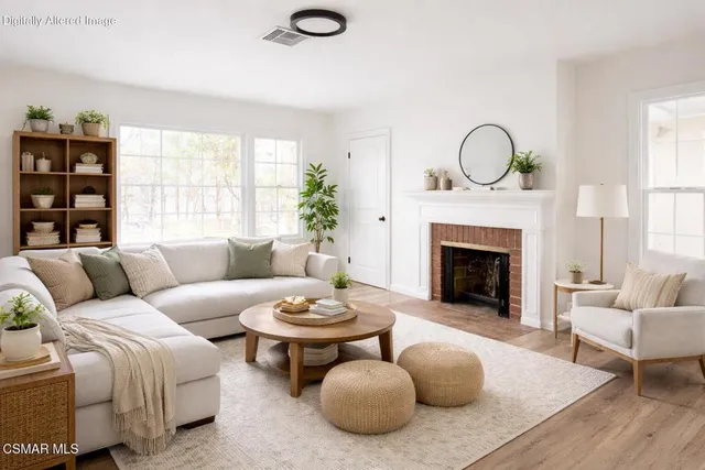 a living room with furniture a fireplace and window
