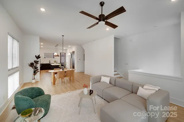 a kitchen with a table chairs refrigerator and microwave