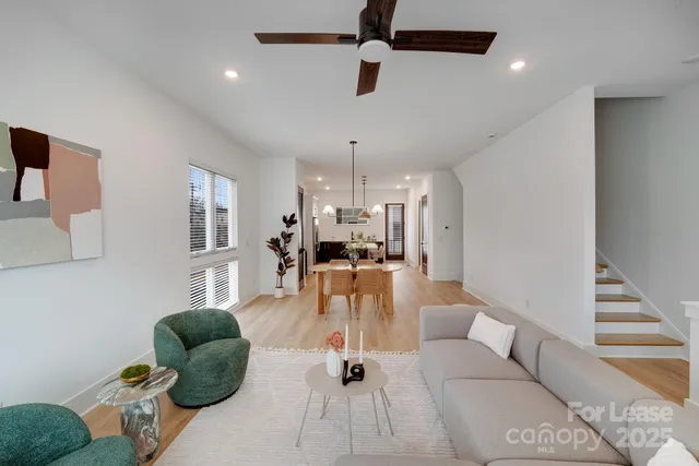 a living room with furniture potted plant and a window