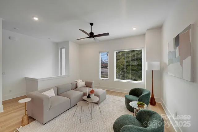 a kitchen with stainless steel appliances a dining table chairs and couches