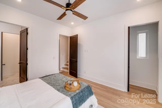 a bedroom with a large bed and a window