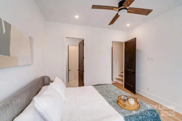 a bedroom with a bed chair and window