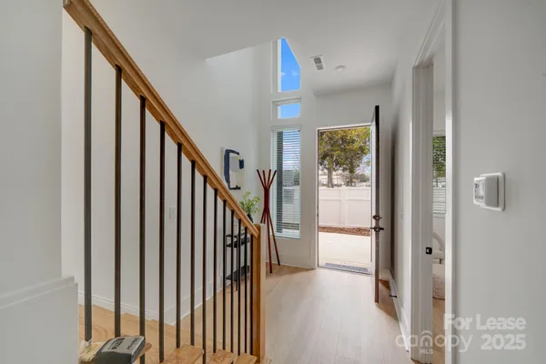 a view of a hallway with wooden floor and entryway