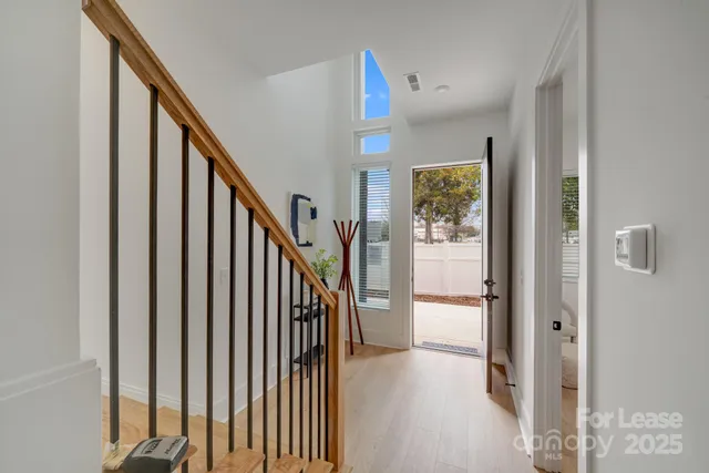 a view of a hallway with wooden floor and entryway