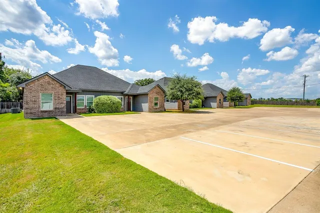 a house view with swimming pool in front of it