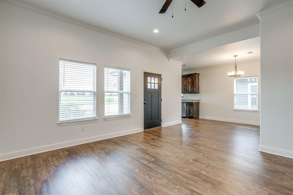 2706 James Road Granbury, TX 76049 - Photo 15 of 23 an empty room with wooden floor and windows
