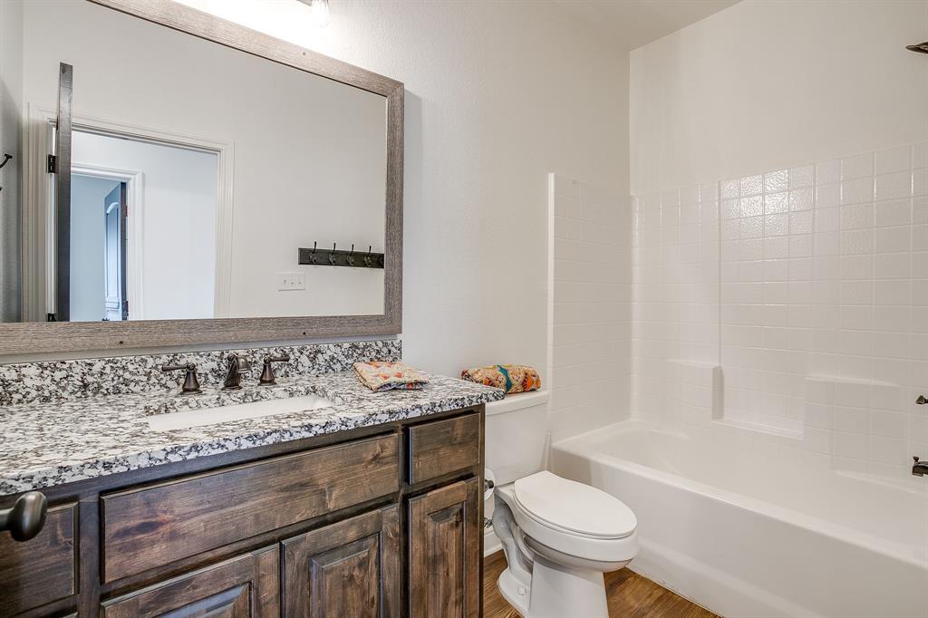 2706 James Road Granbury, TX 76049 - Photo 17 of 23 a bathroom with a sink toilet vanity and tub
