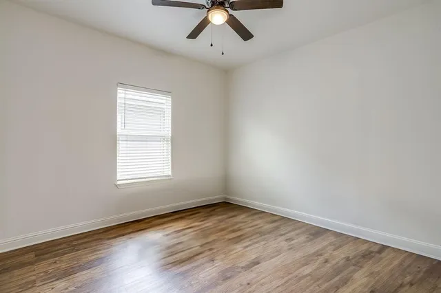 wooden floor in an empty room with a window