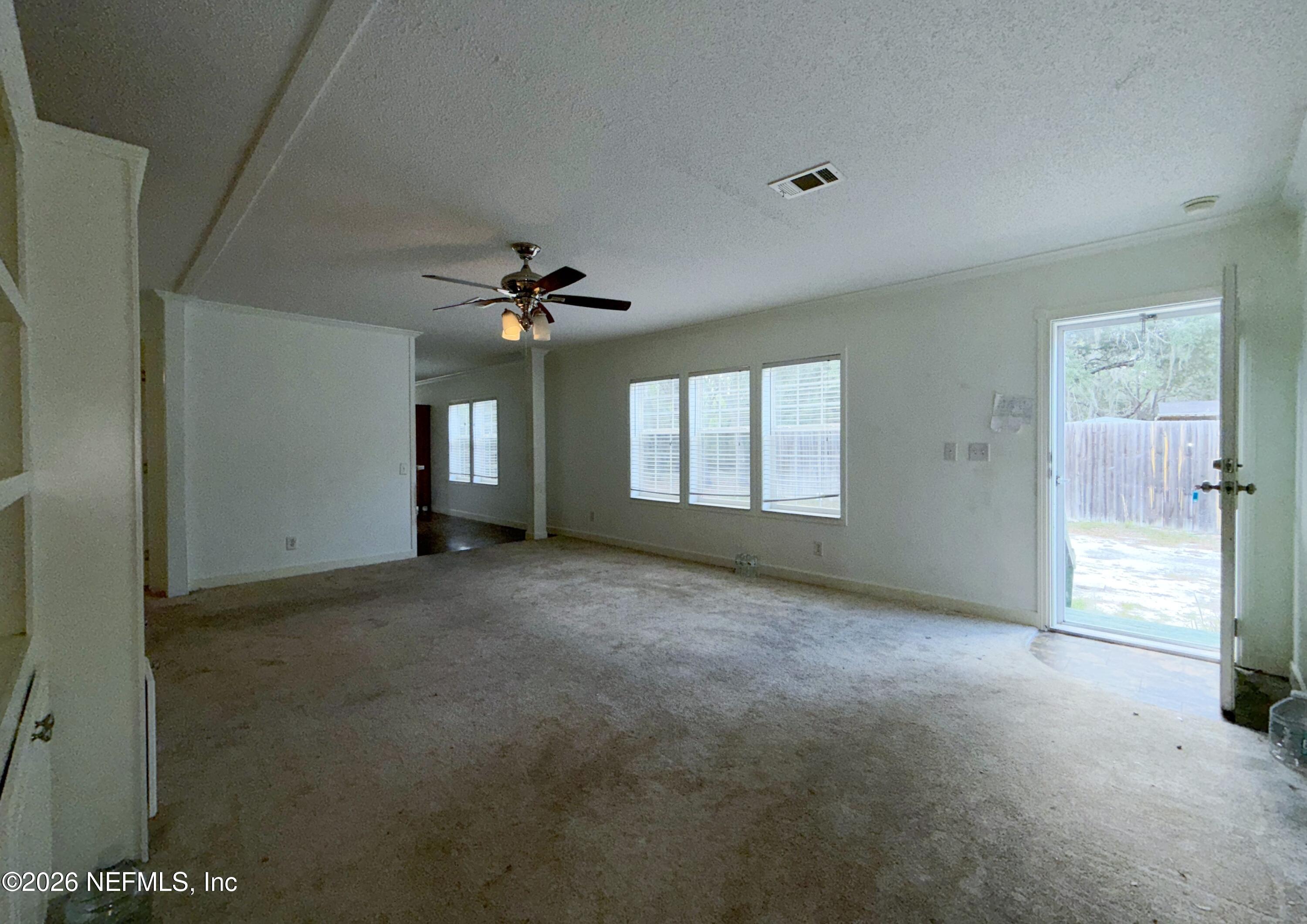 136 Short Pine Road Hawthorne, FL 32640 - Photo 12 of 39 a view of a big room with windows and chandelier fan