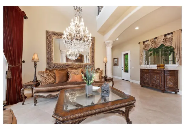a kitchen with granite countertop a stove a sink and a refrigerator