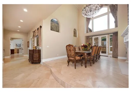 a dining room with furniture a chandelier and wooden floor