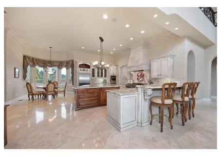 a living room with furniture large window and a fireplace