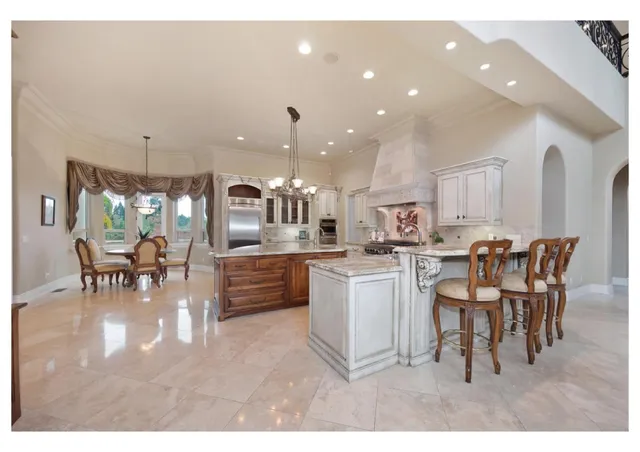 a living room with furniture large window and a fireplace