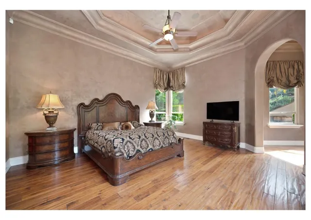 a bedroom with a large bed and a large window