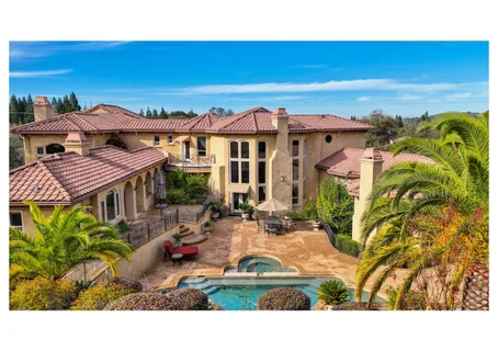 a living room with furniture a chandelier a fireplace and a chandelier