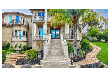 a living room with furniture a flat screen tv and a floor to ceiling window