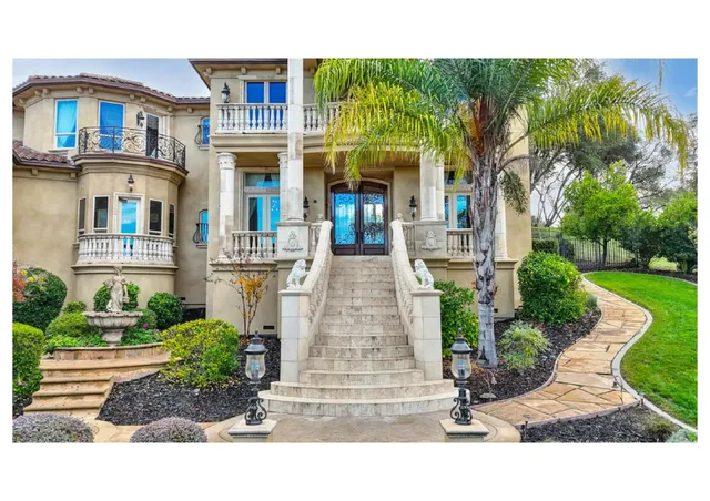 a living room with furniture a flat screen tv and a floor to ceiling window