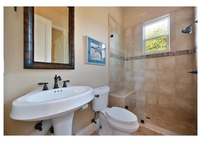 a bedroom with furniture and a large window